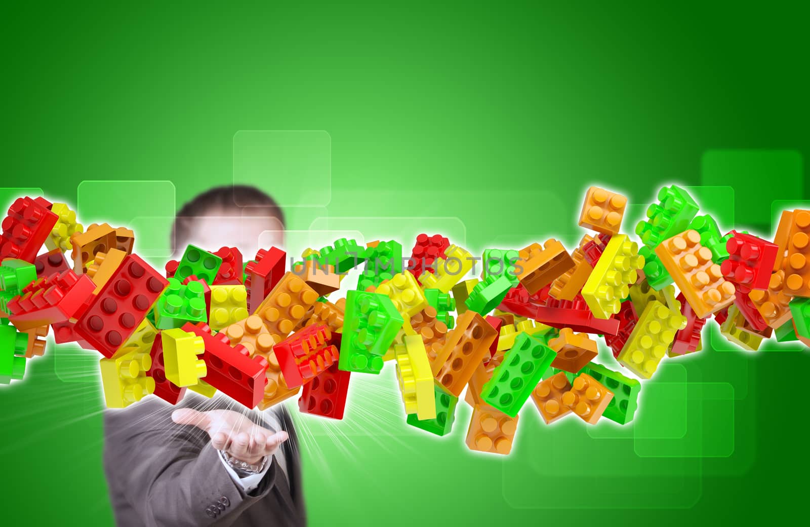 Businessman in suit hold flow of childrens blocks on background of rectangles
