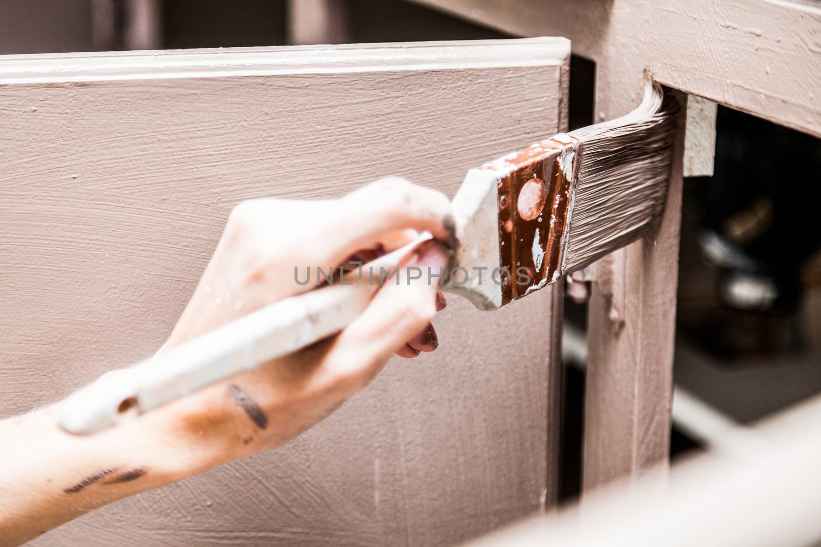 Closeup of Person Painting Kitchen Cabinets by aetb