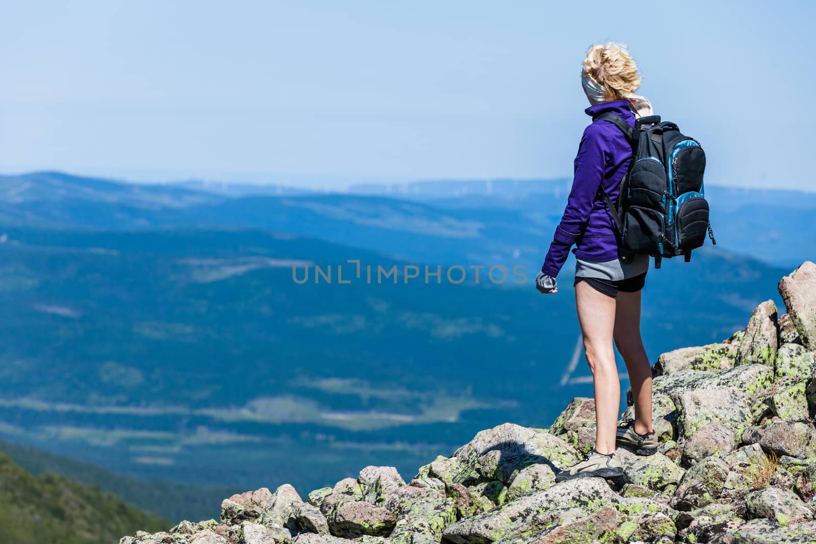 Young Woman Looking at the View From the Top of the Hill by aetb
