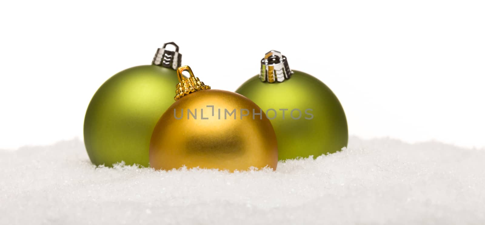 Beautiful Green and Yellow Christmas Ornaments on Snow Flakes Isolated on a White Background.