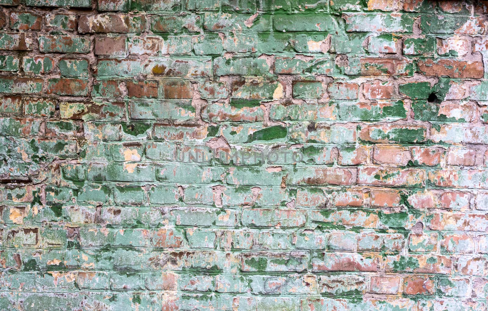 Background of old vintage dirty brick wall with peeling plaster, texture