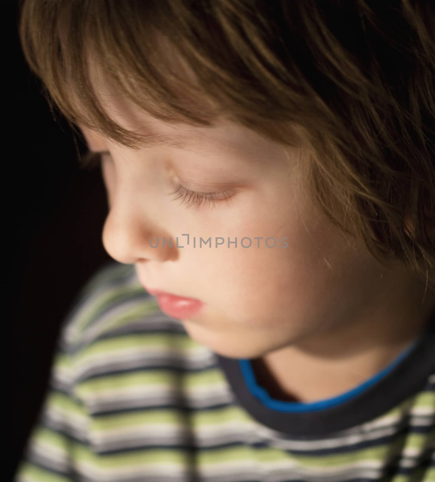 Portrait of a Boy with Blond Hair Looking Down