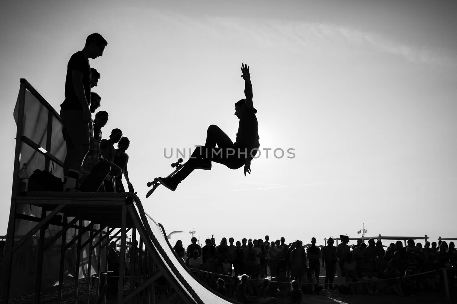 Picture of a silhouette of a jumping skater on a ramp in black and white.