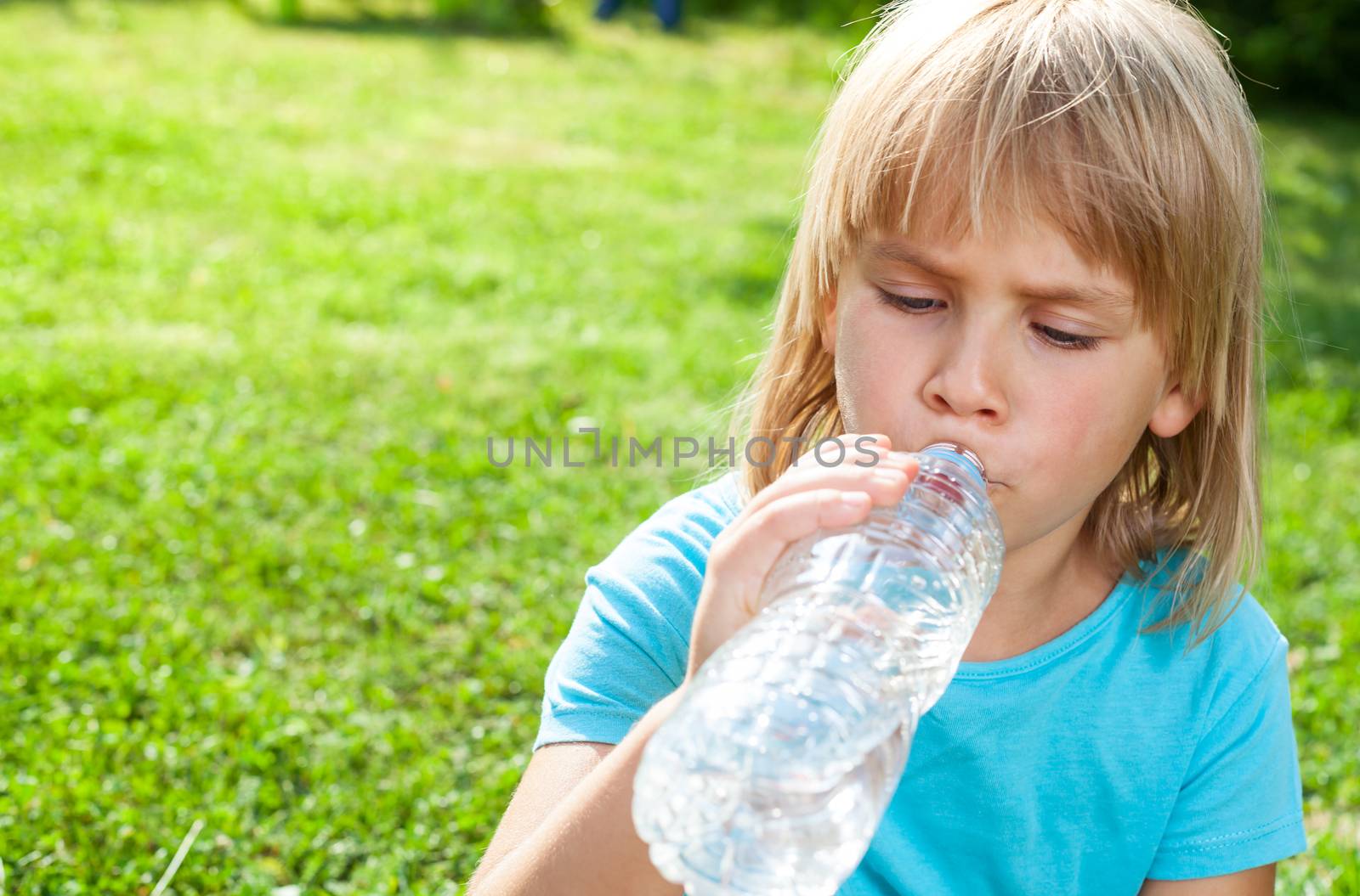 Child drinking water outdoor by naumoid