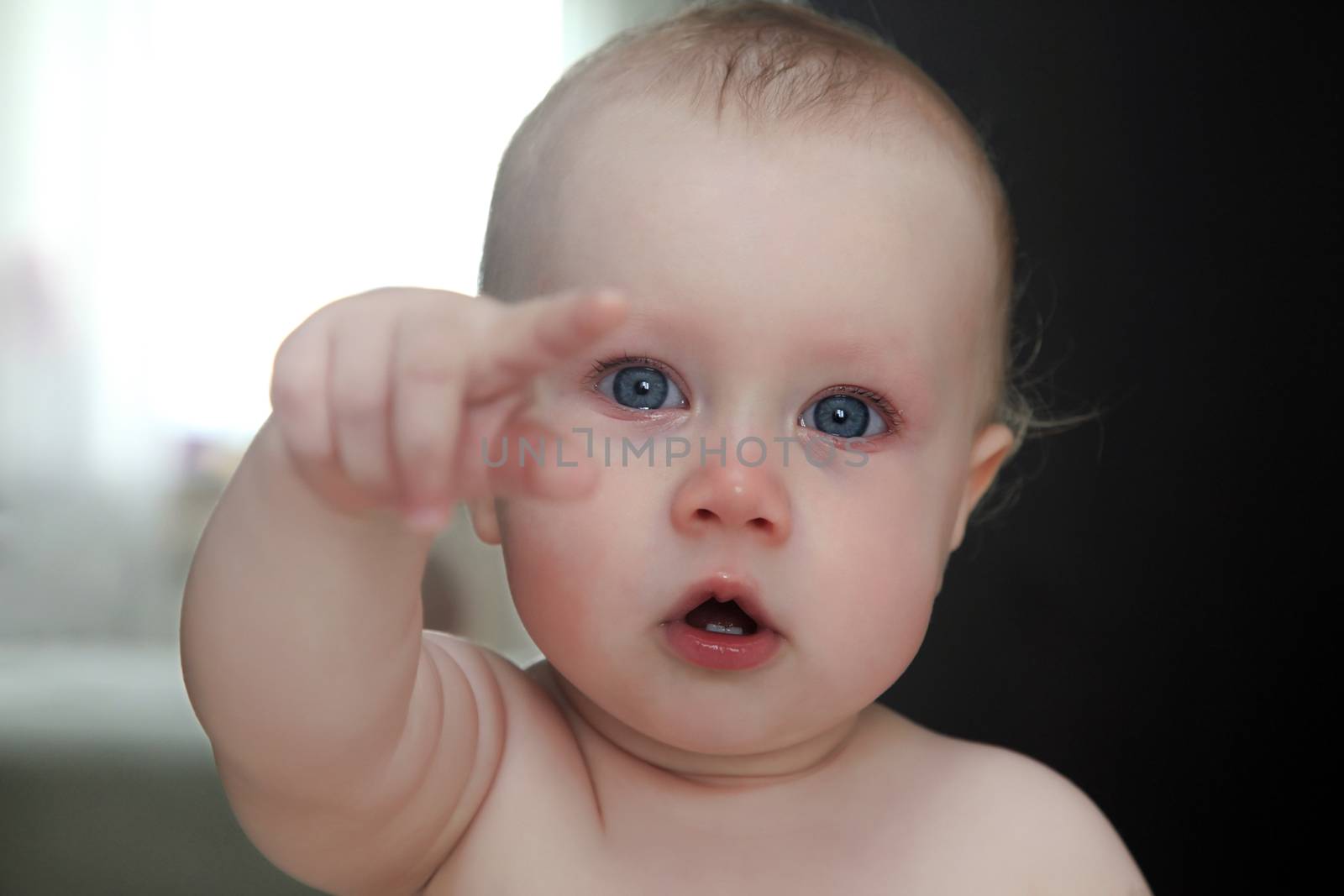 crying little girl shows a finger