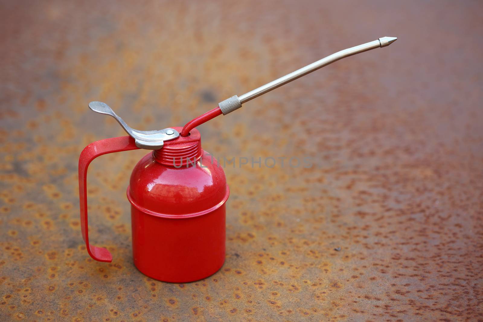 Red oiler close up over rusty grunge background