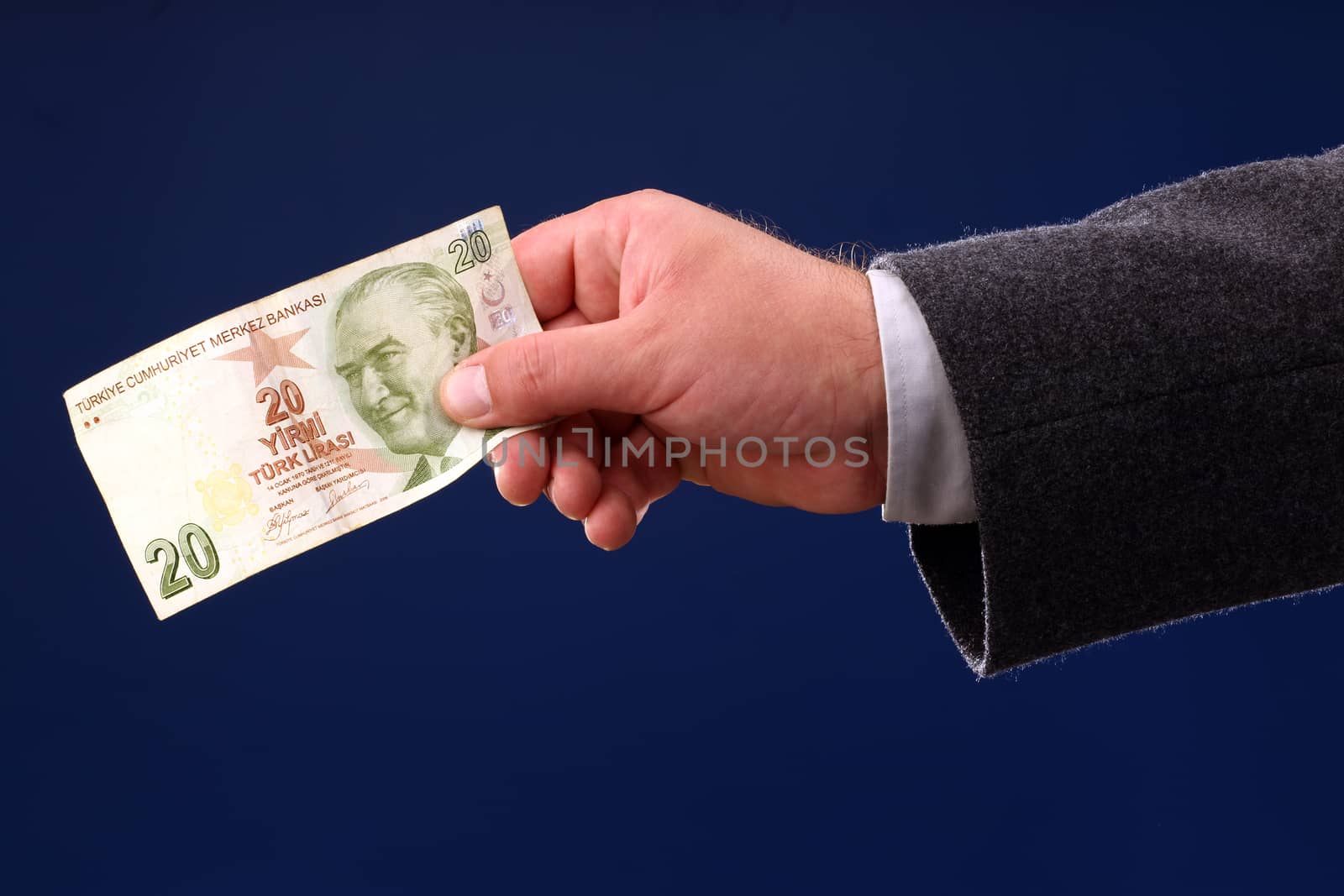 male hand holding a twenty Turkish Liras bill