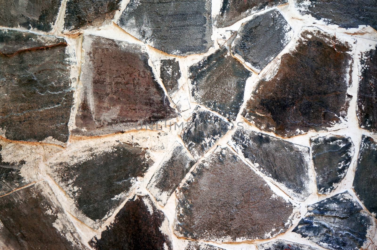 The wall of the large gray-brown stones close-up                               