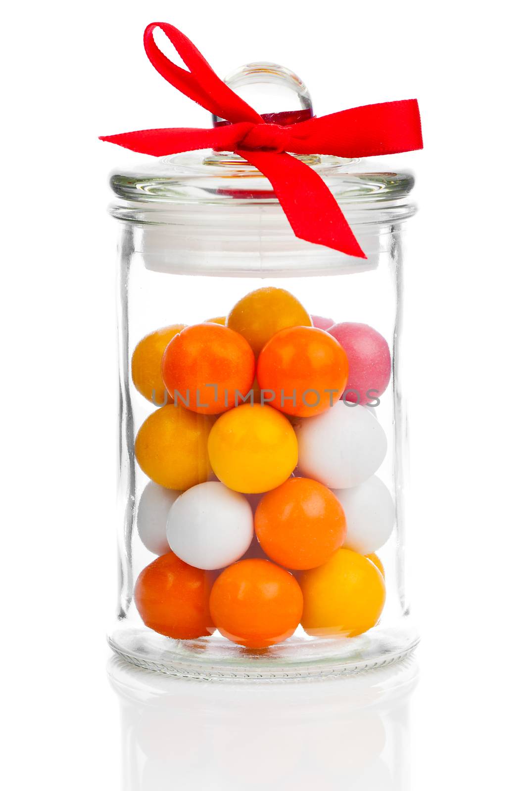 Colorful background of assorted Gumballs in  glass jar,  isolated over white background