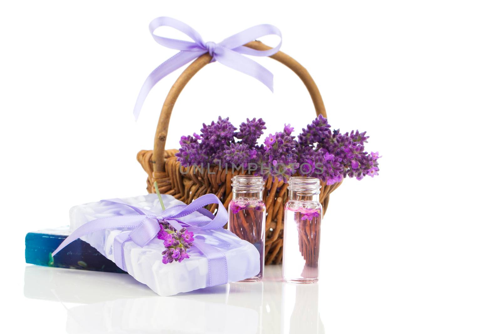 Natural handmade lavender soap and oil with fresh lavender on white background