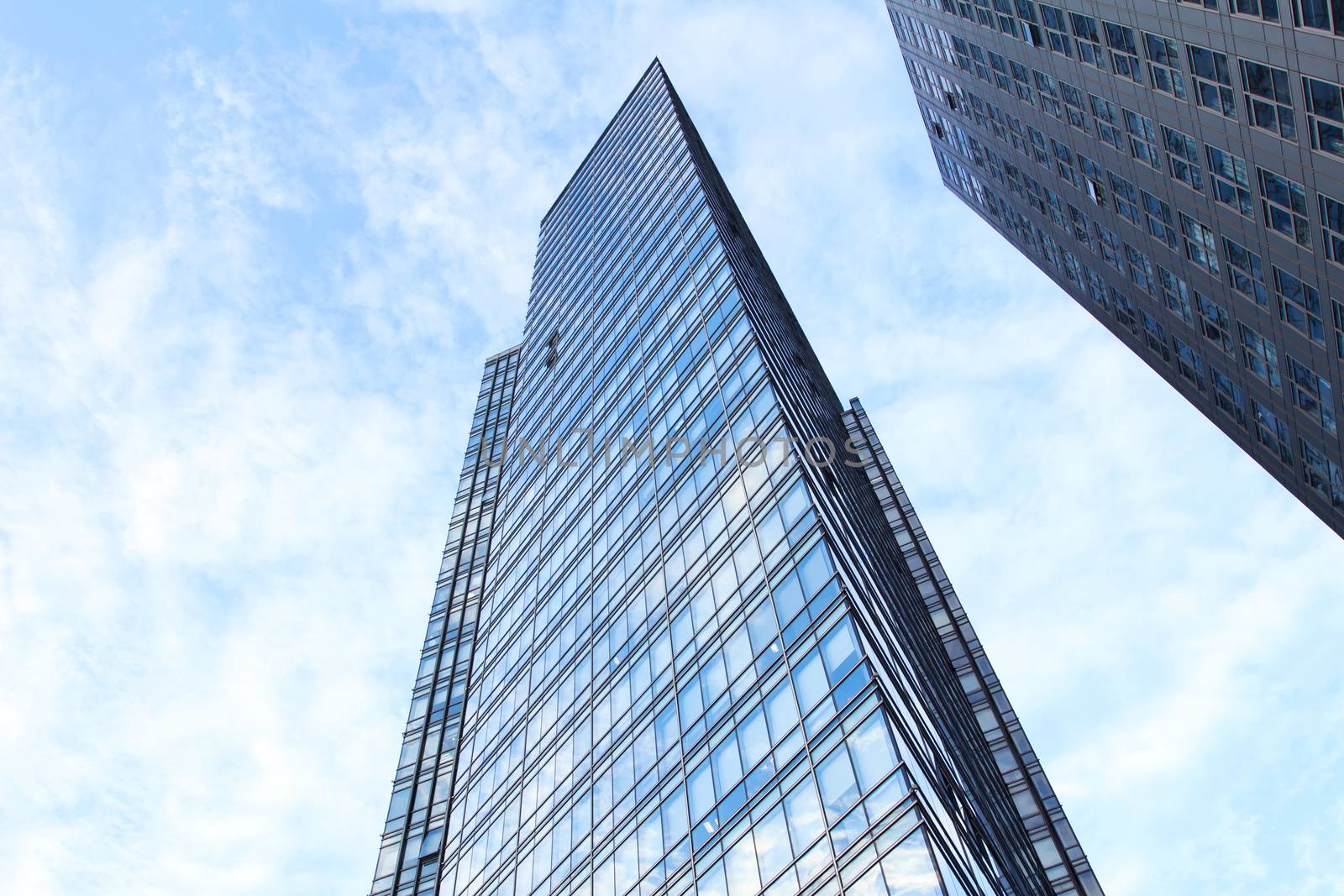 glass wall of office building,with reflection of clouds