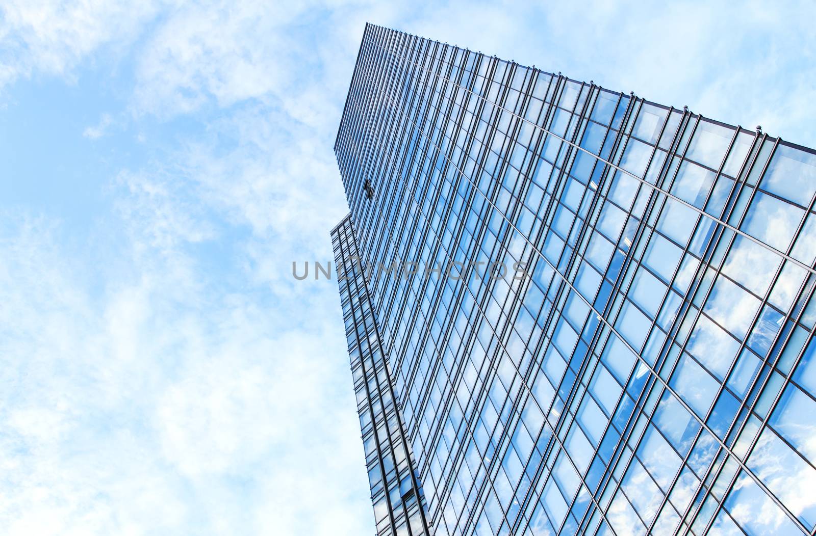 glass wall of office building,with reflection of clouds
