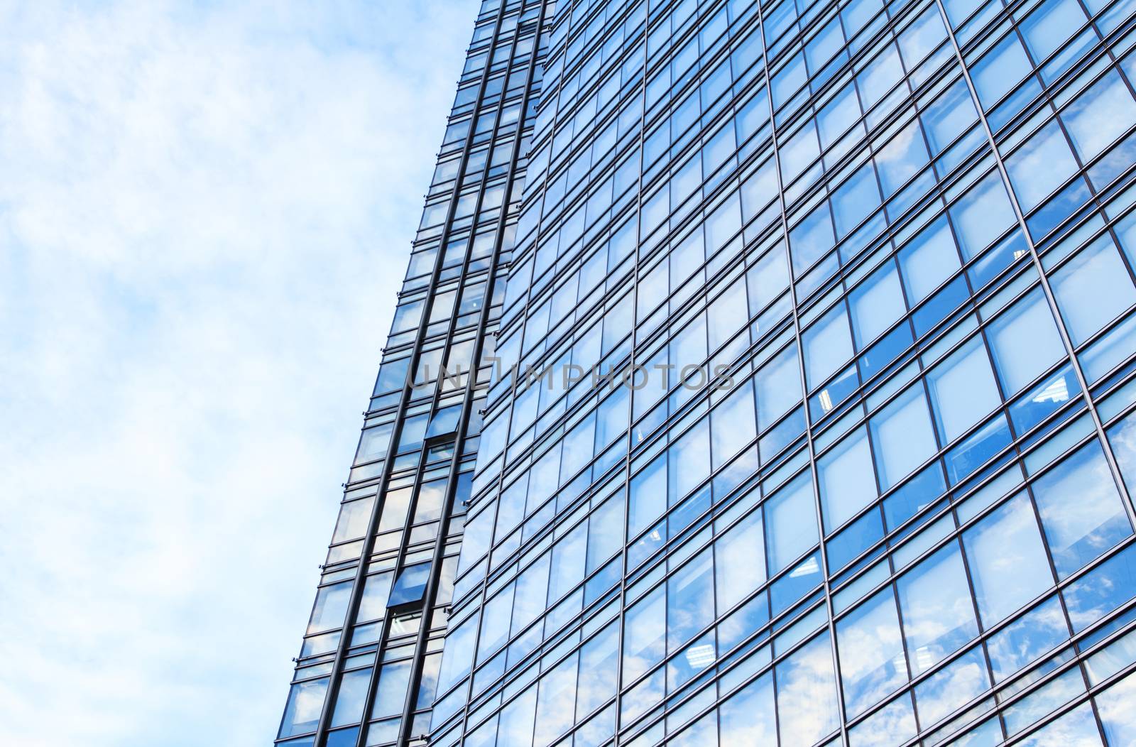 glass wall of office building,with reflection of clouds