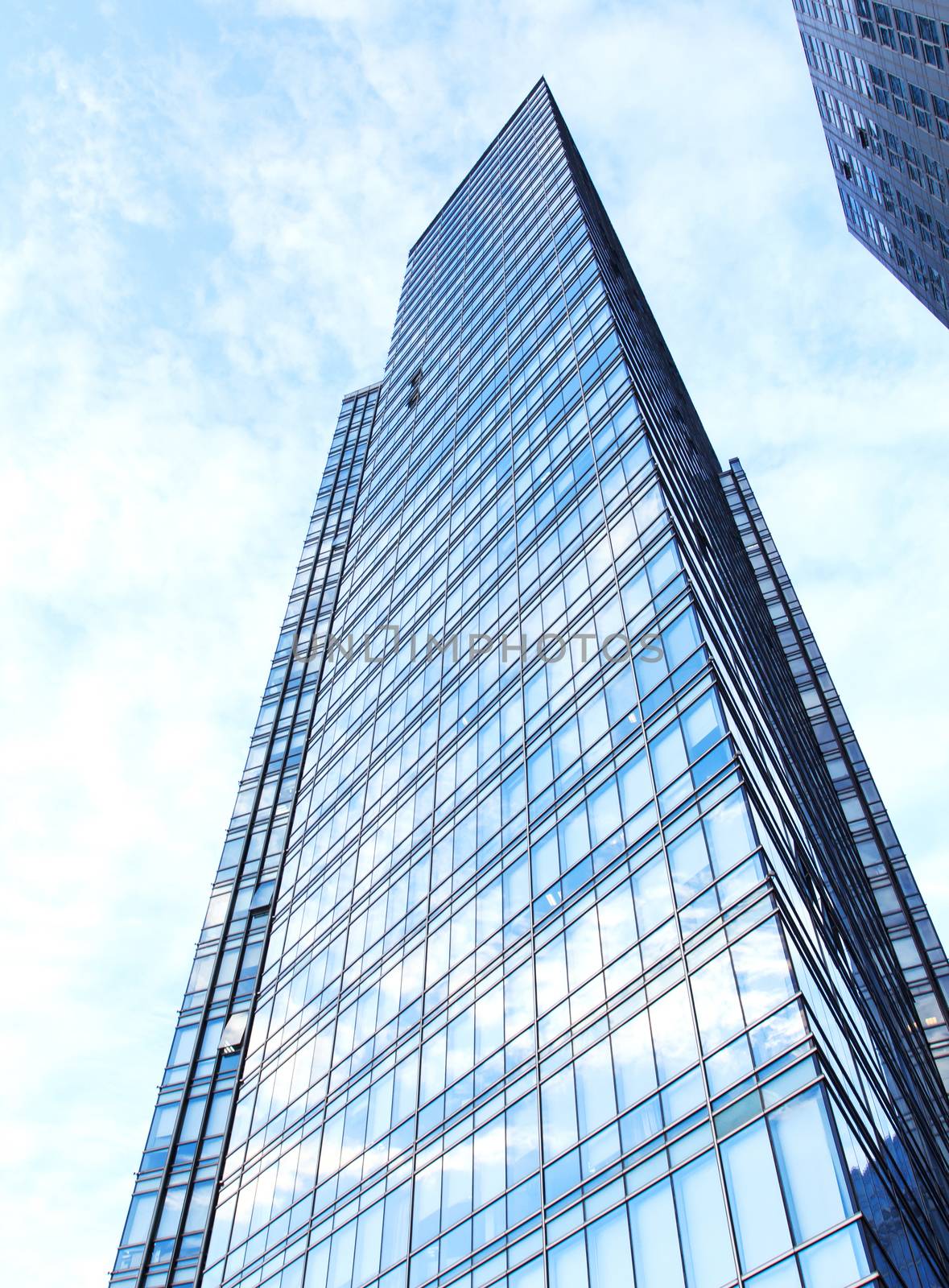 glass wall of office building,with reflection of clouds