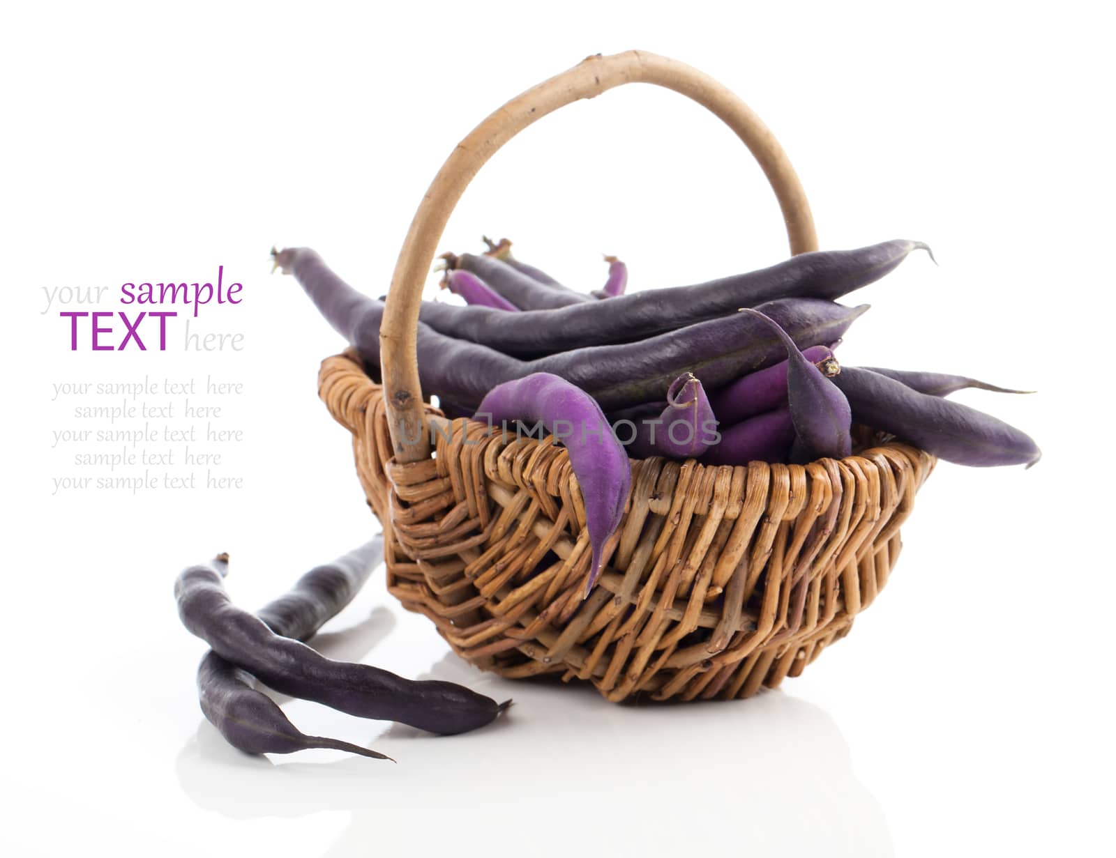 Red bean pods in wicker basket over white background