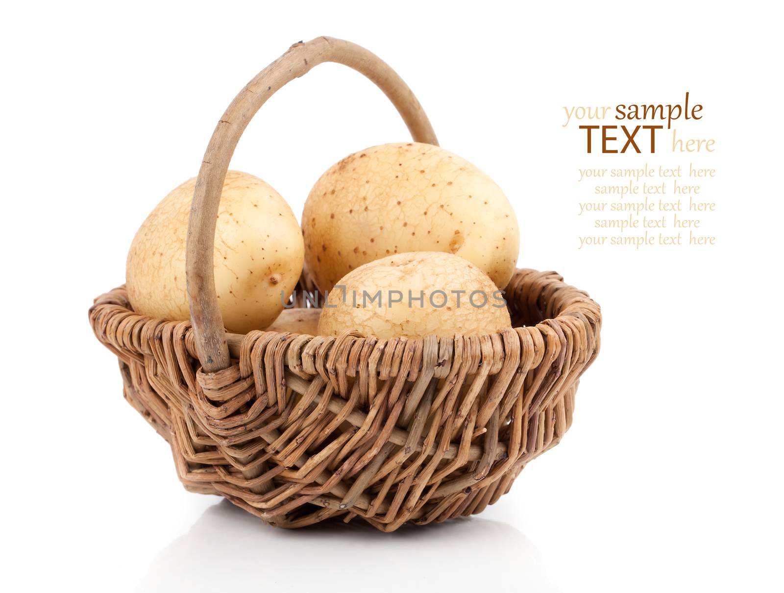 Golden Potatoes in wicker basket over white background