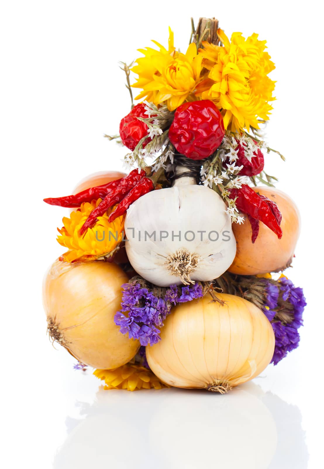 Braided bunch with onions, garlic and flowers, over white backgr by motorolka