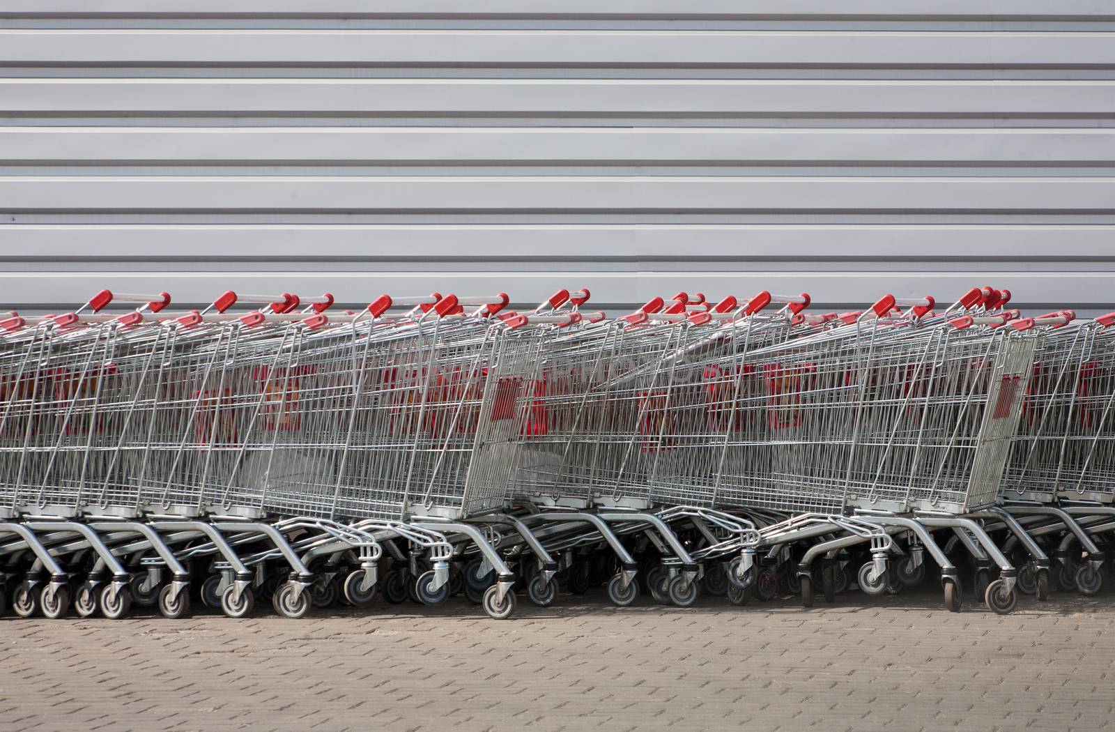 number of metal carts at supermarket wall