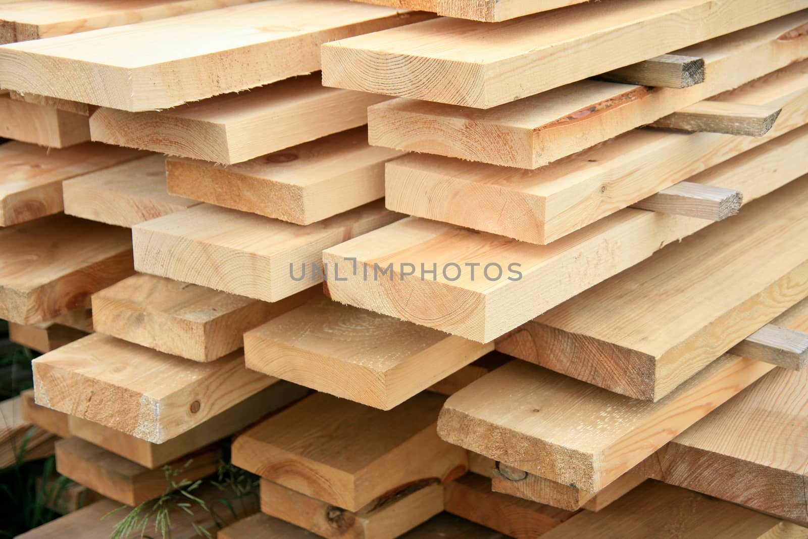 New pine boards in stacks outside