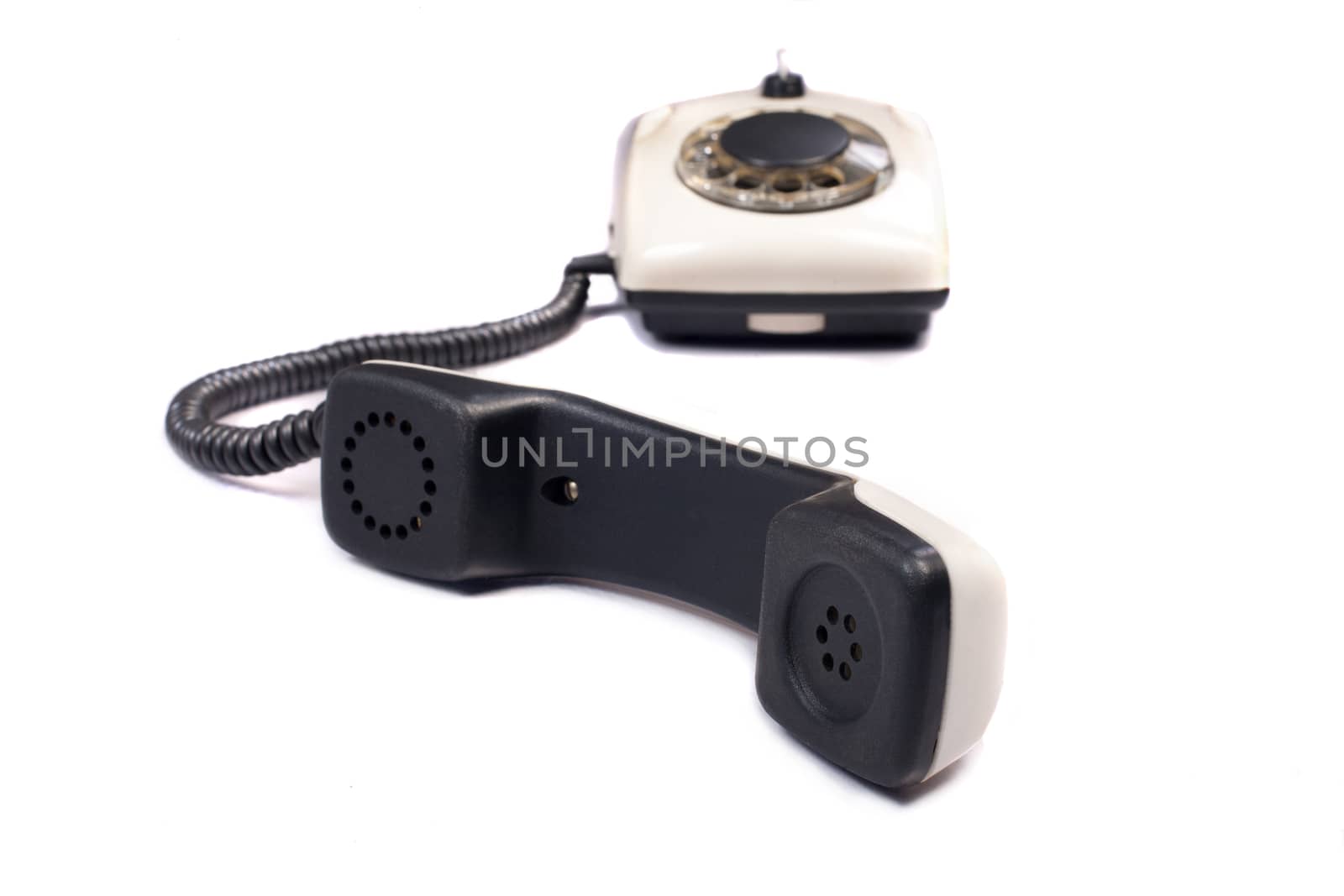 Old disk phone on white background