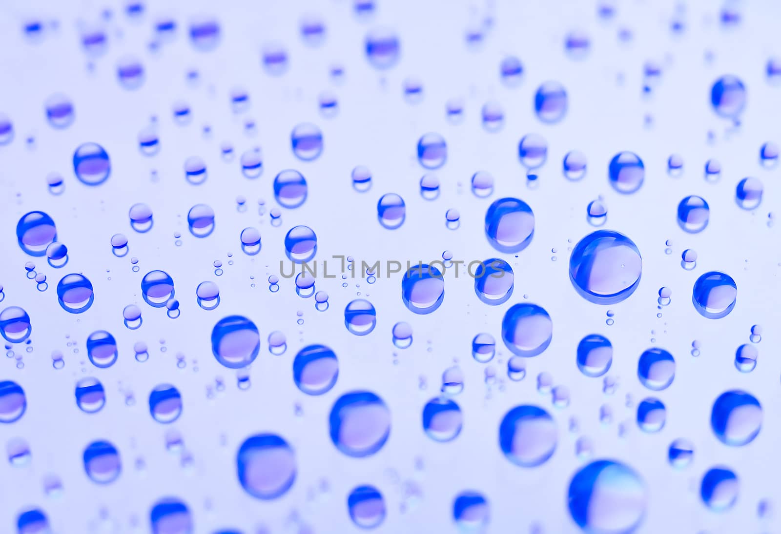 Beautiful blue convex drops on  flat reflecting surface
