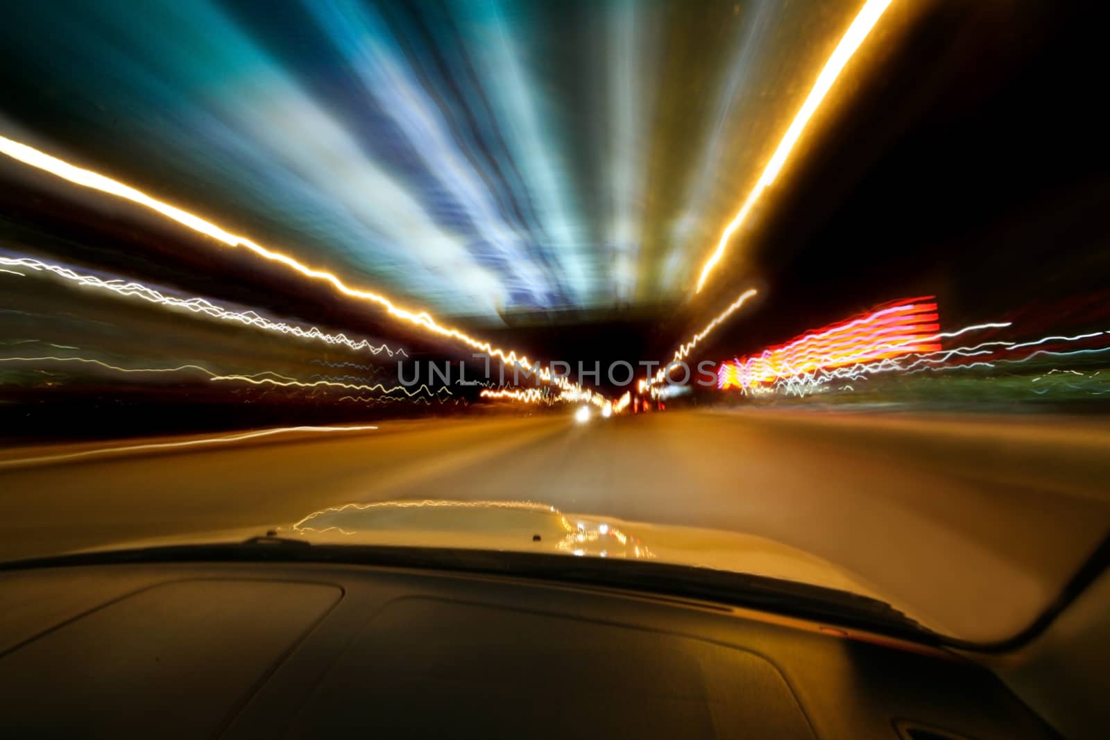 Car goes on  night city in  tunnel