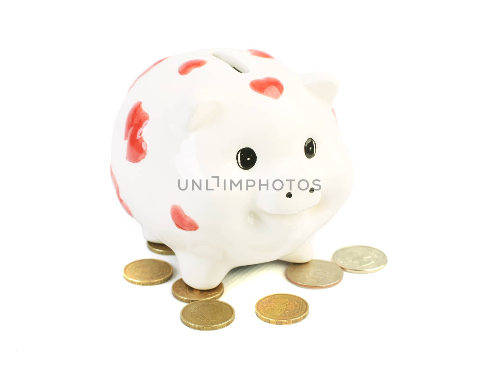 White coin box pig and coins isolated