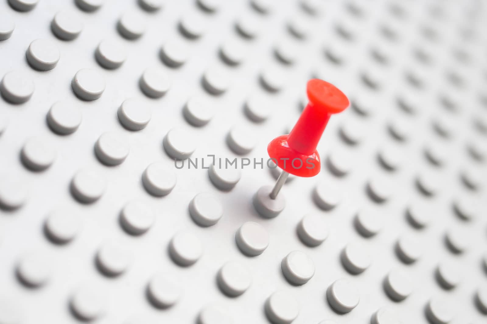red writing button in grey textural surface