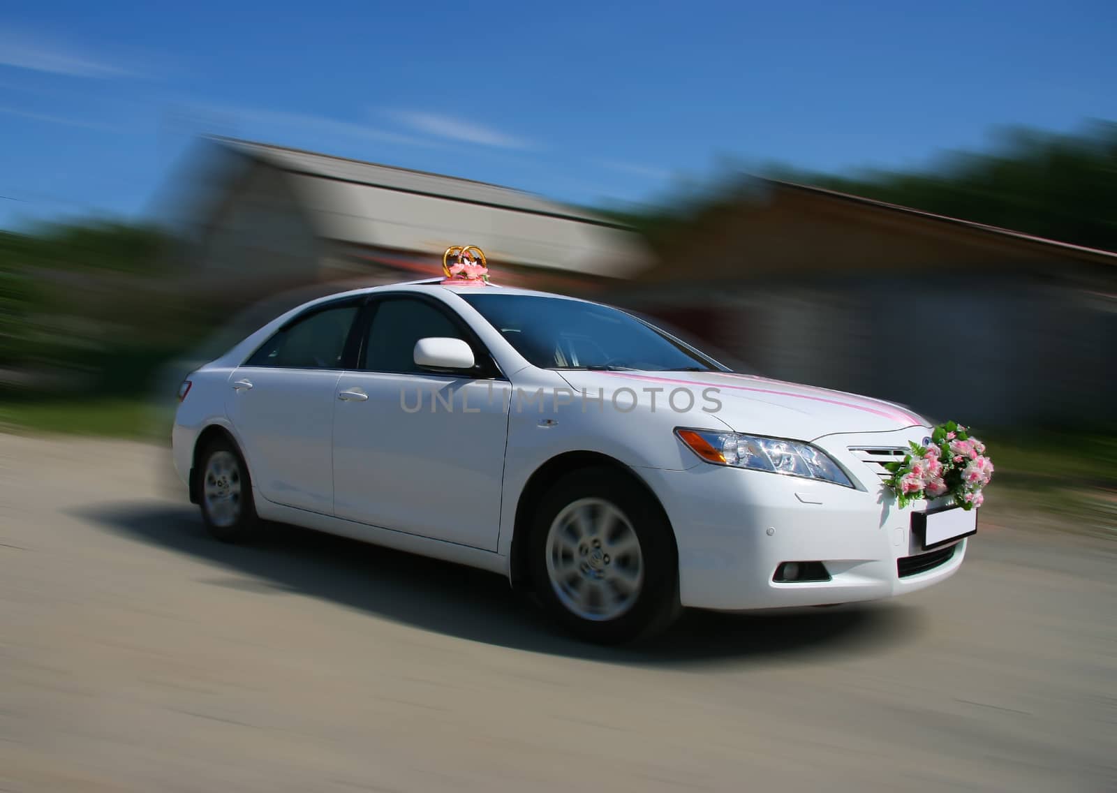 white wedding car goes along street settlement