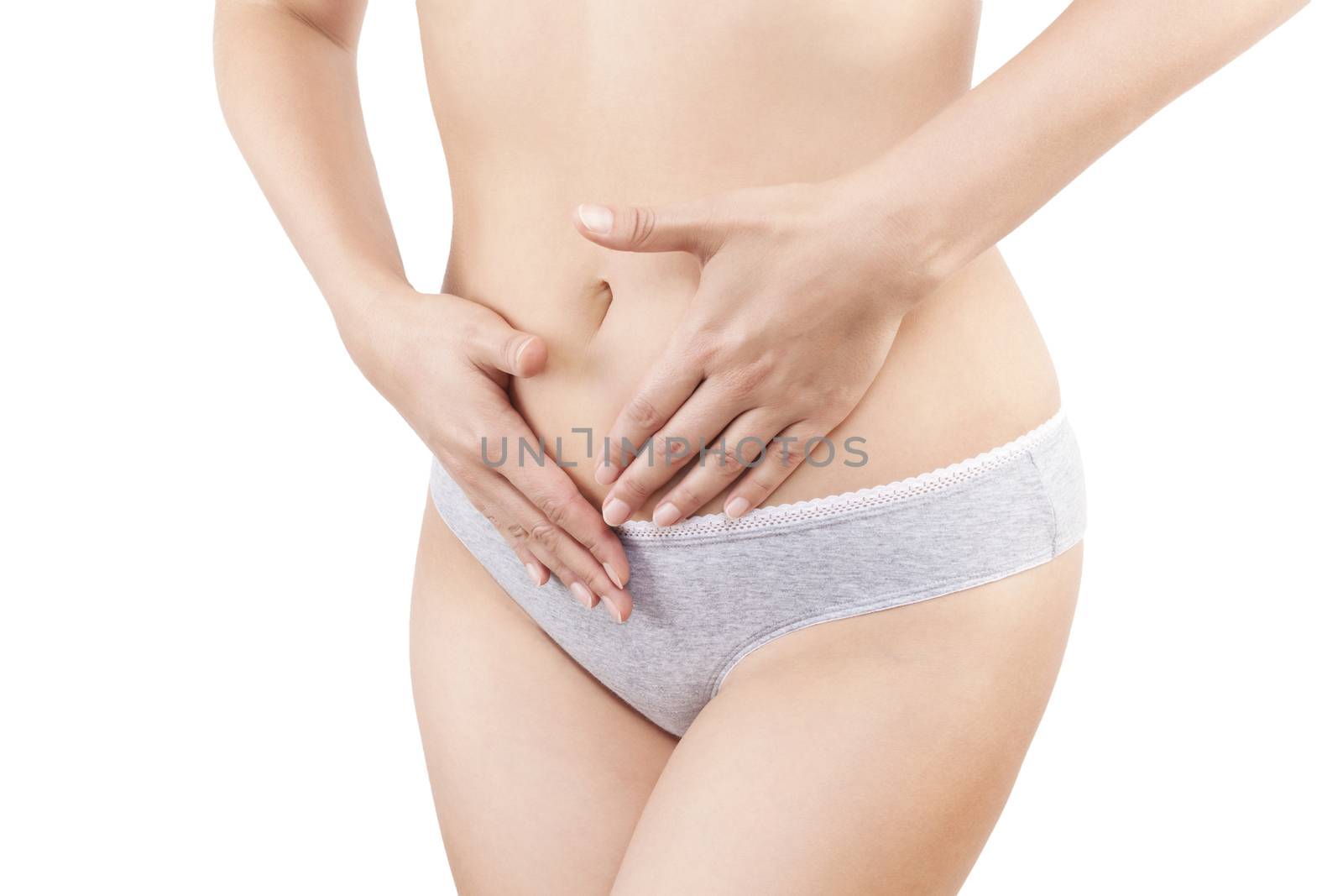 Slim belly. Beautiful woman touching her belly in grey panties isolated on white background. Menstruation, period, pregnancy and weight loss. Feminine body.