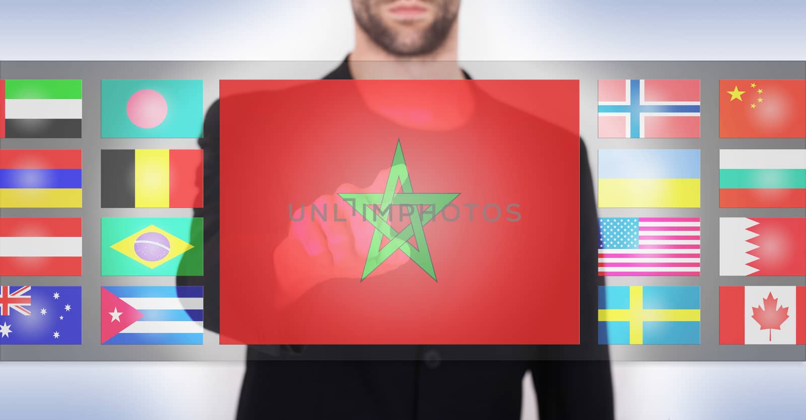 Hand pushing on a touch screen interface, choosing language or country, Morocco