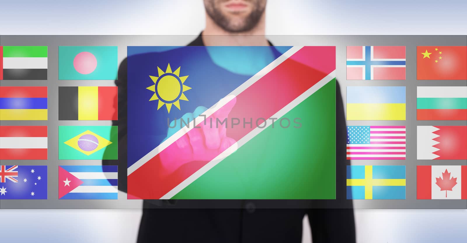 Hand pushing on a touch screen interface, choosing language or country, Namibia