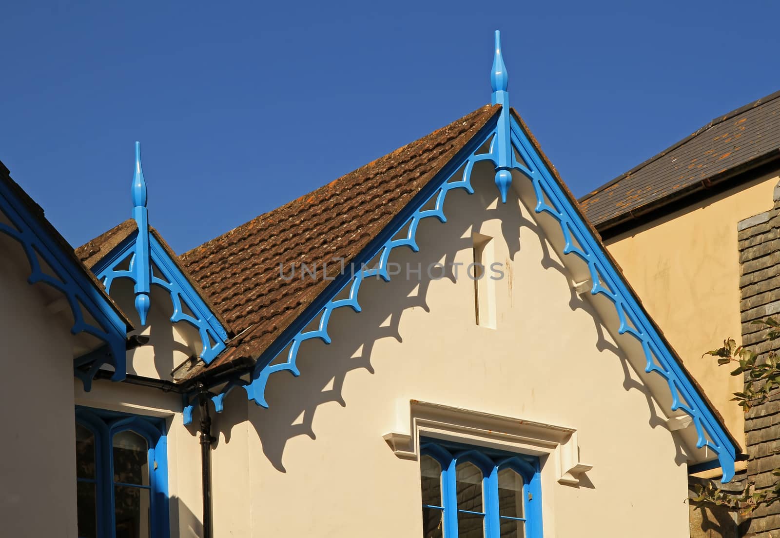 The front of some buildings, with ornate roof overhangs