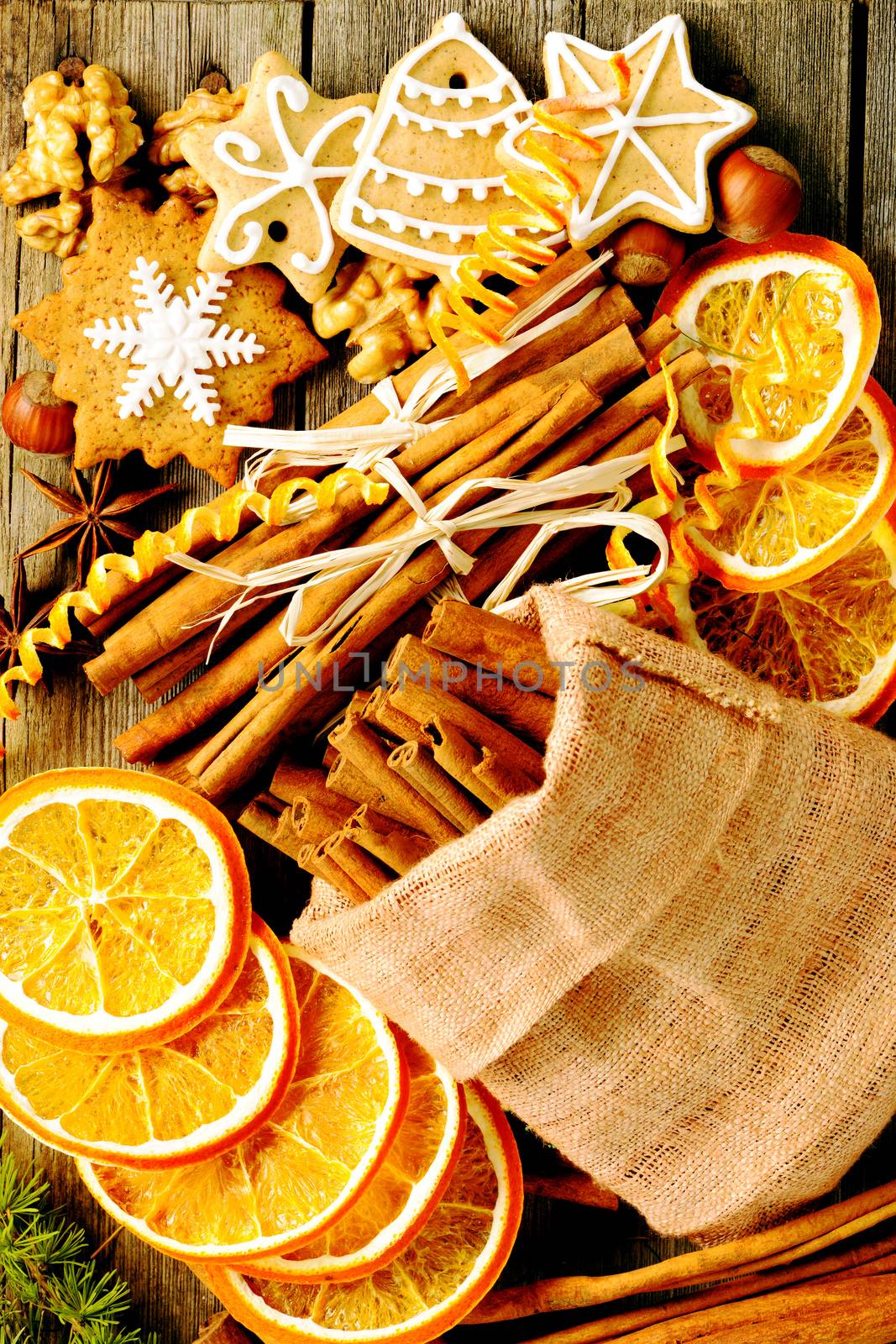 Christmas homemade gingerbread cookie and spices over wooden table