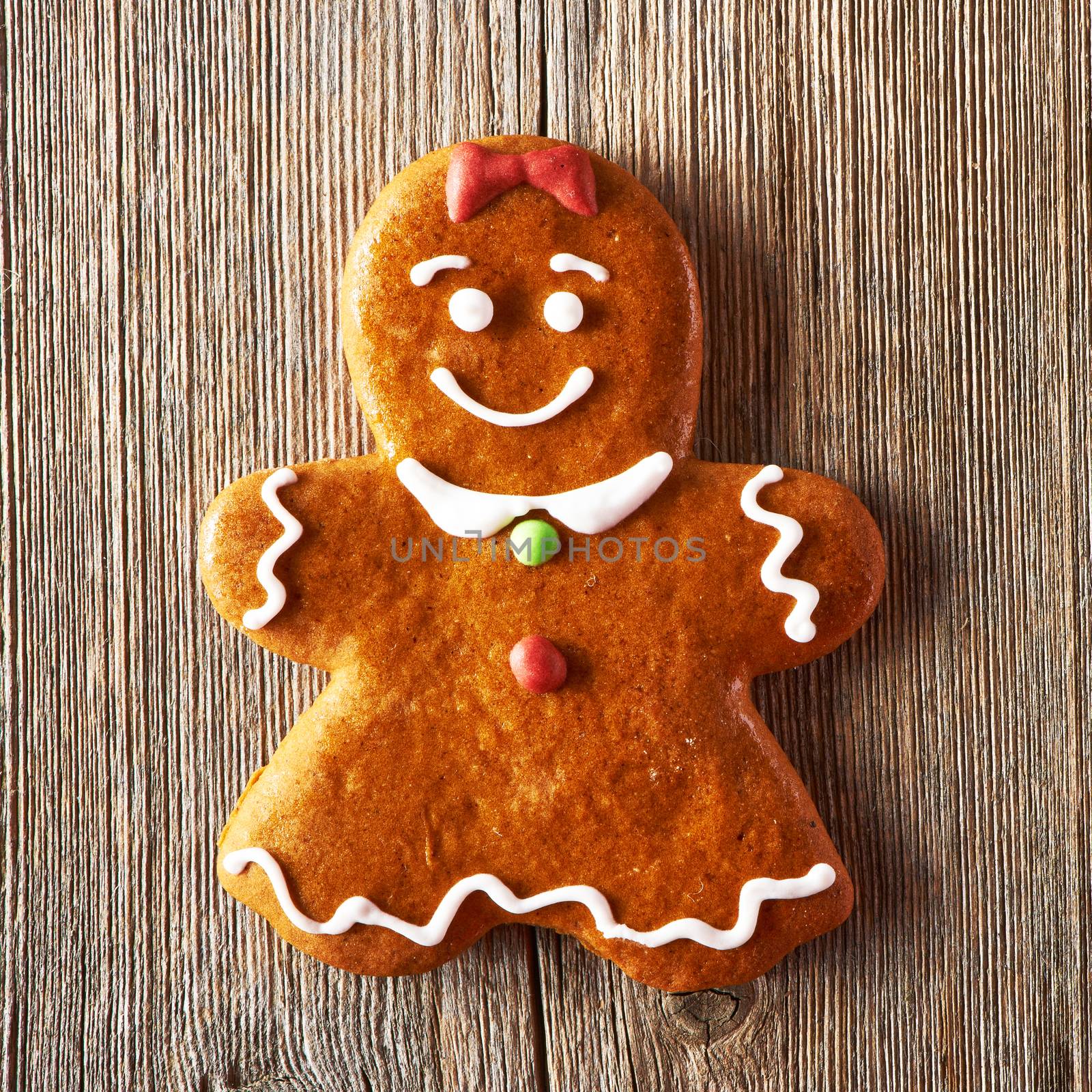 Christmas homemade gingerbread girl on wooden table