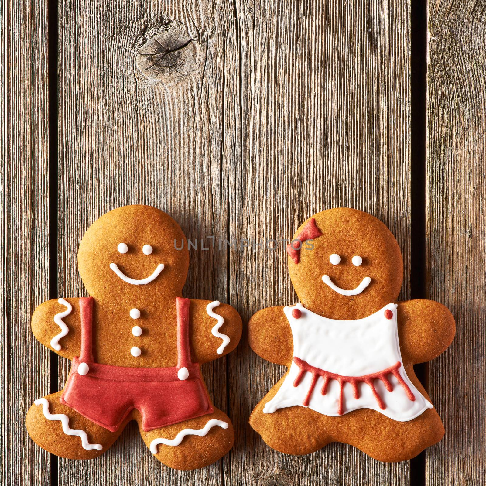 Christmas homemade gingerbread couple cookies on wooden table