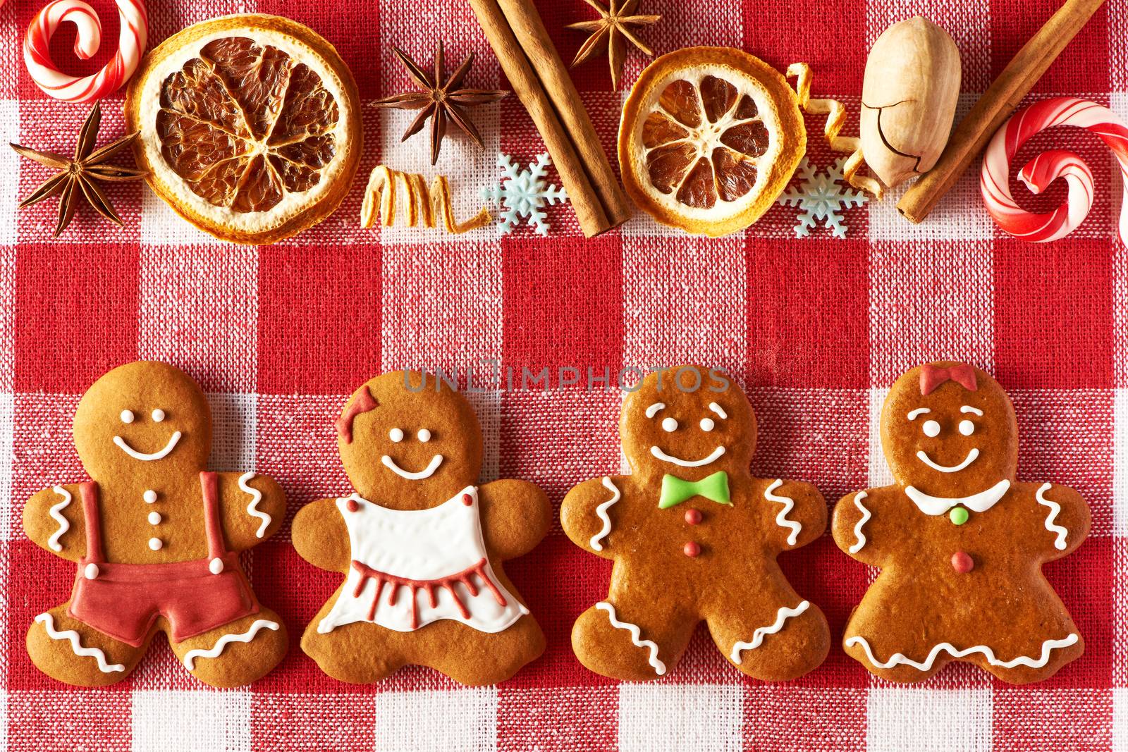 Christmas homemade gingerbread couples on tablecloth