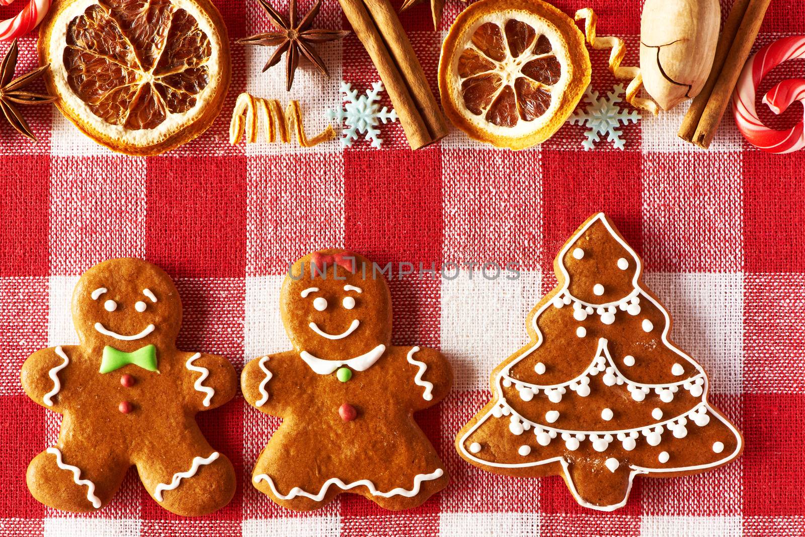 Christmas homemade gingerbread couple and tree on tablecloth