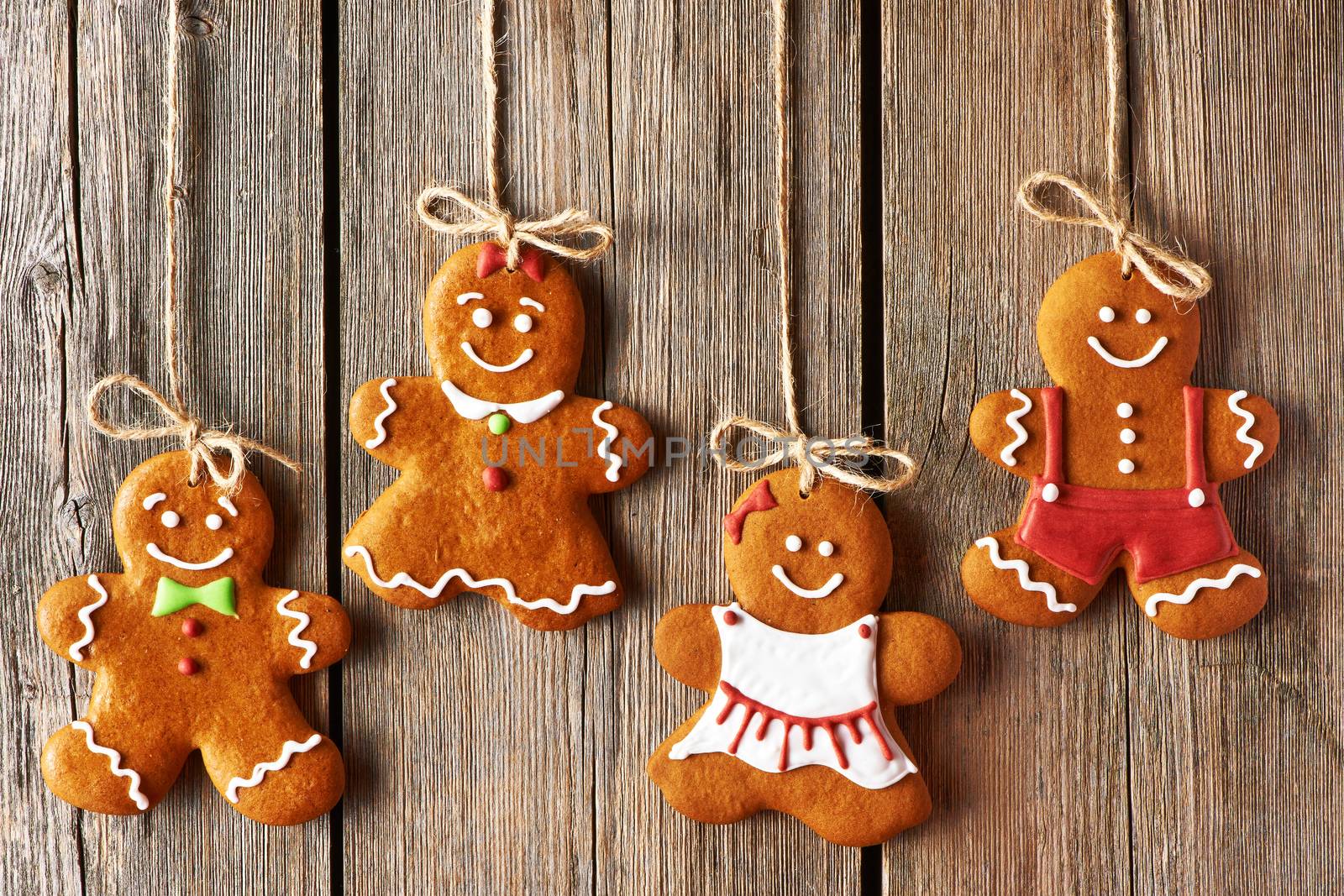 Christmas homemade gingerbread couple cookies over wooden background