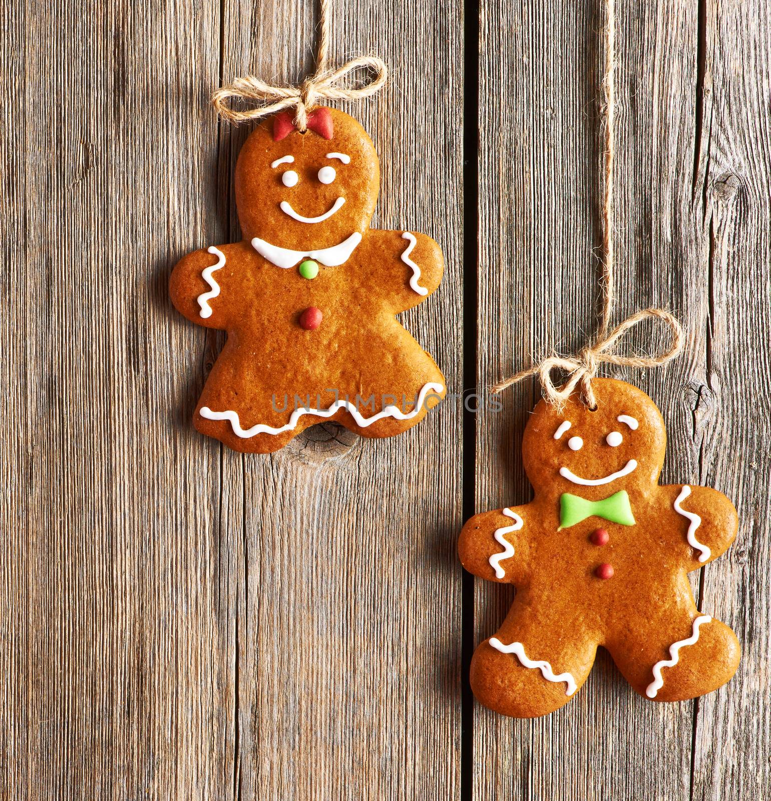 Christmas homemade gingerbread couple cookies over wooden background