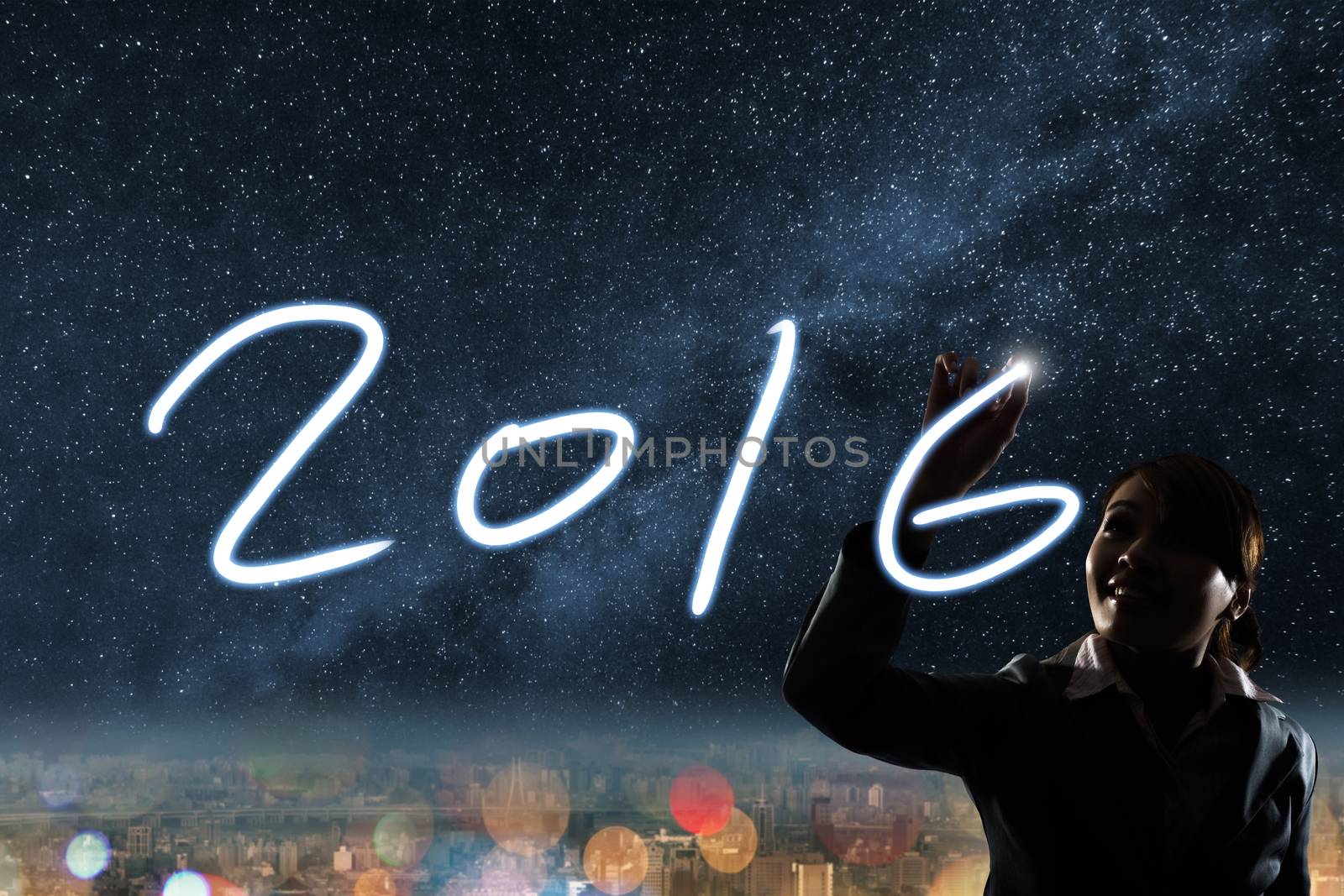 Concept of 2016, silhouette asian business woman light drawing.