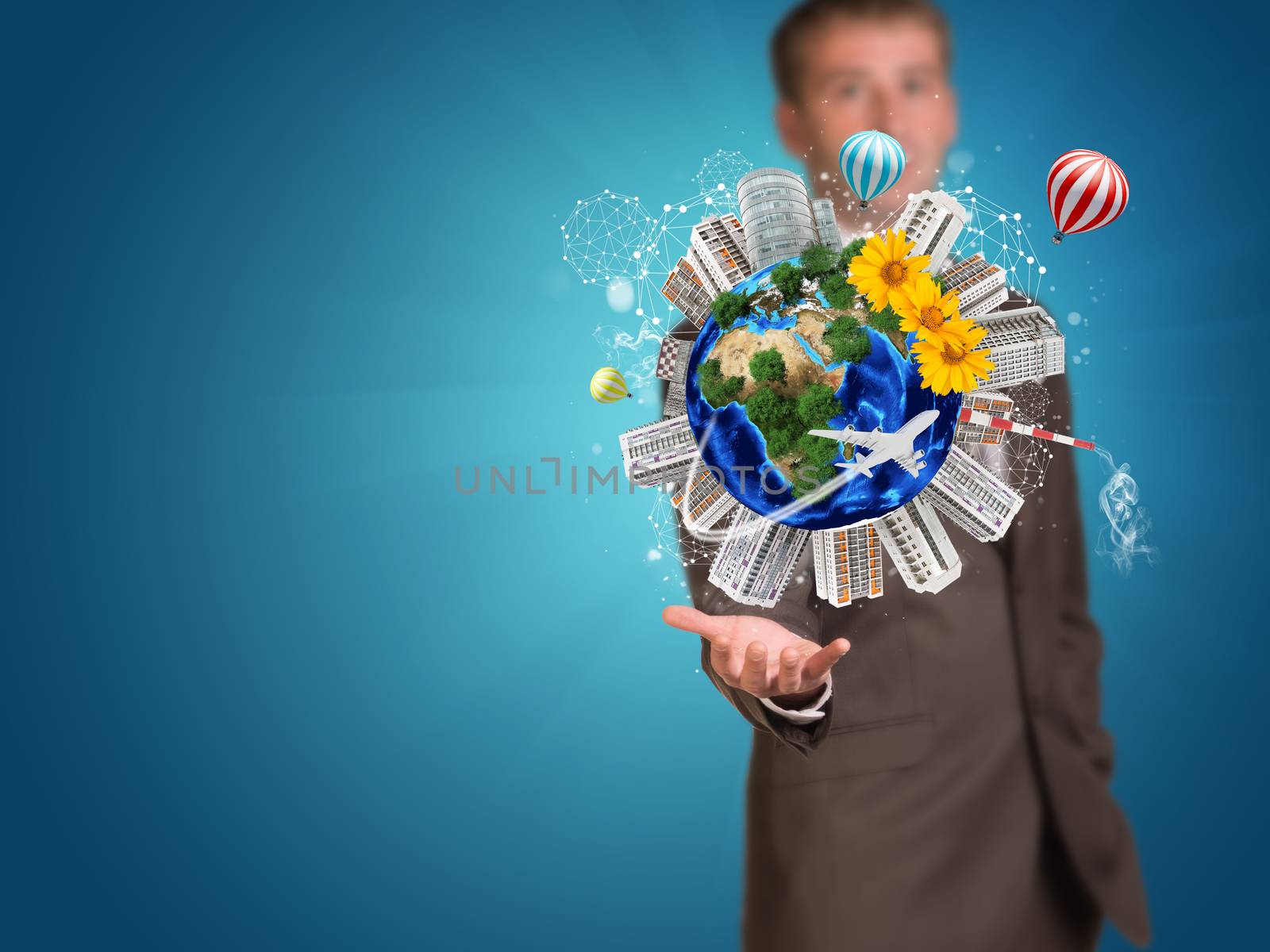 Businessman holding earth with buildings by cherezoff