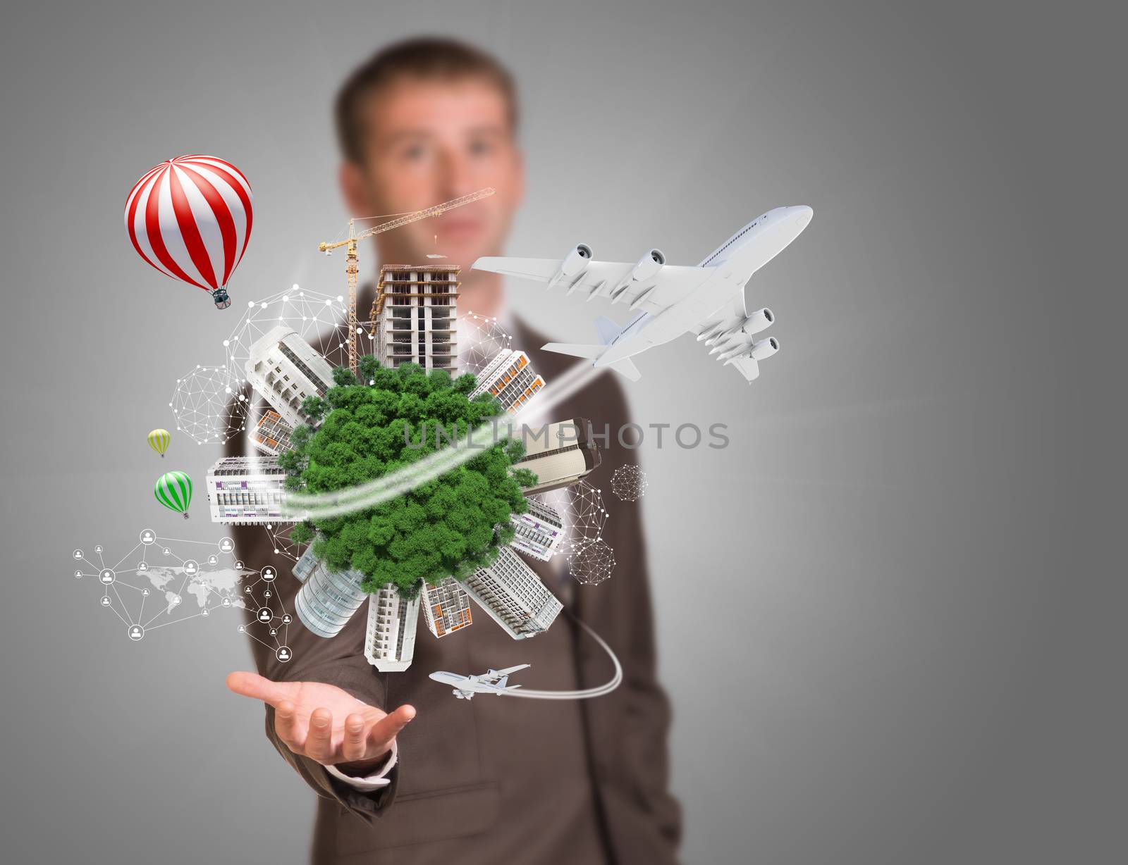 Businessman holding earth with buildings. Business concept