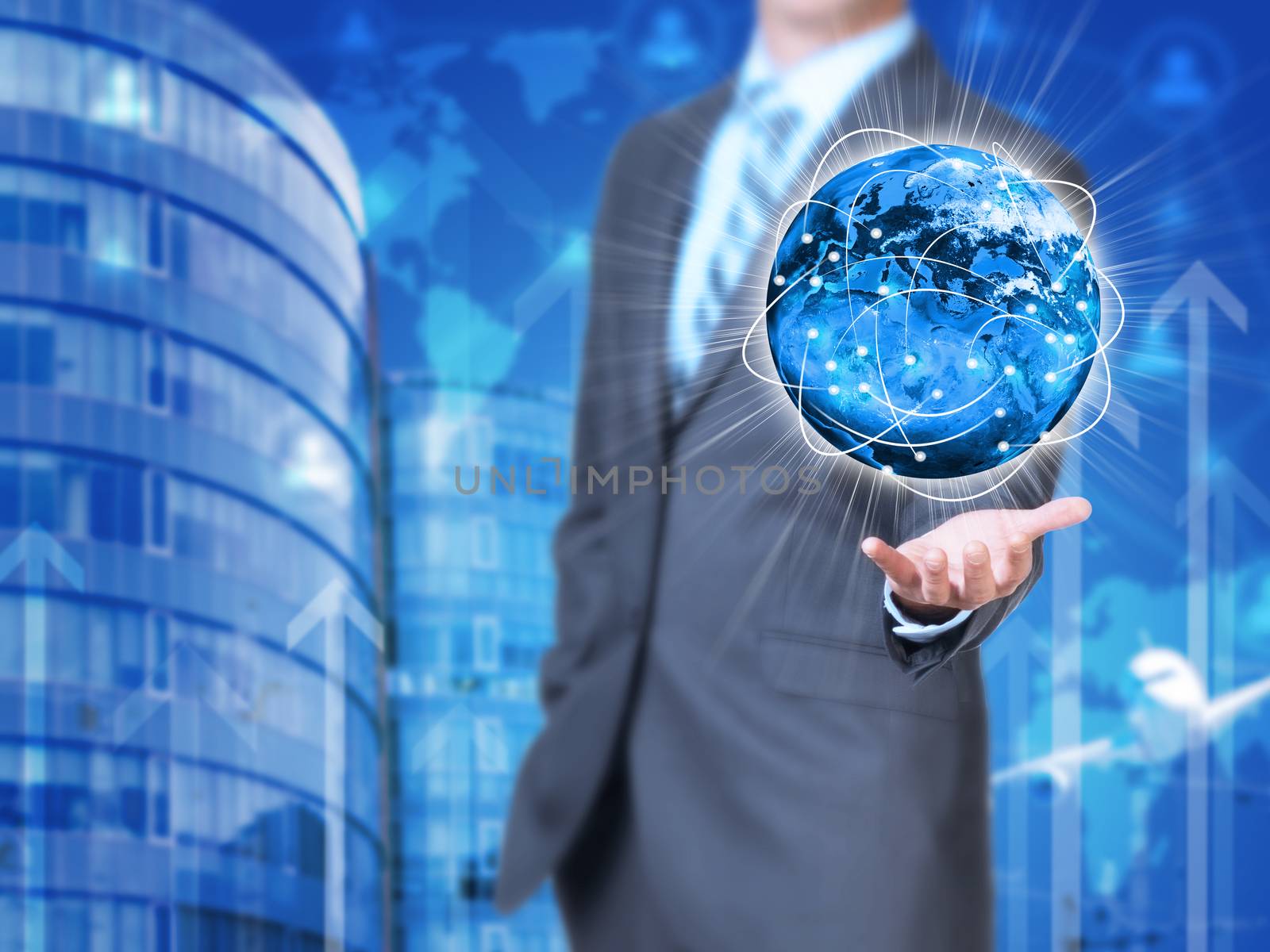 Businessman holding earth. Buildings as backdrop by cherezoff