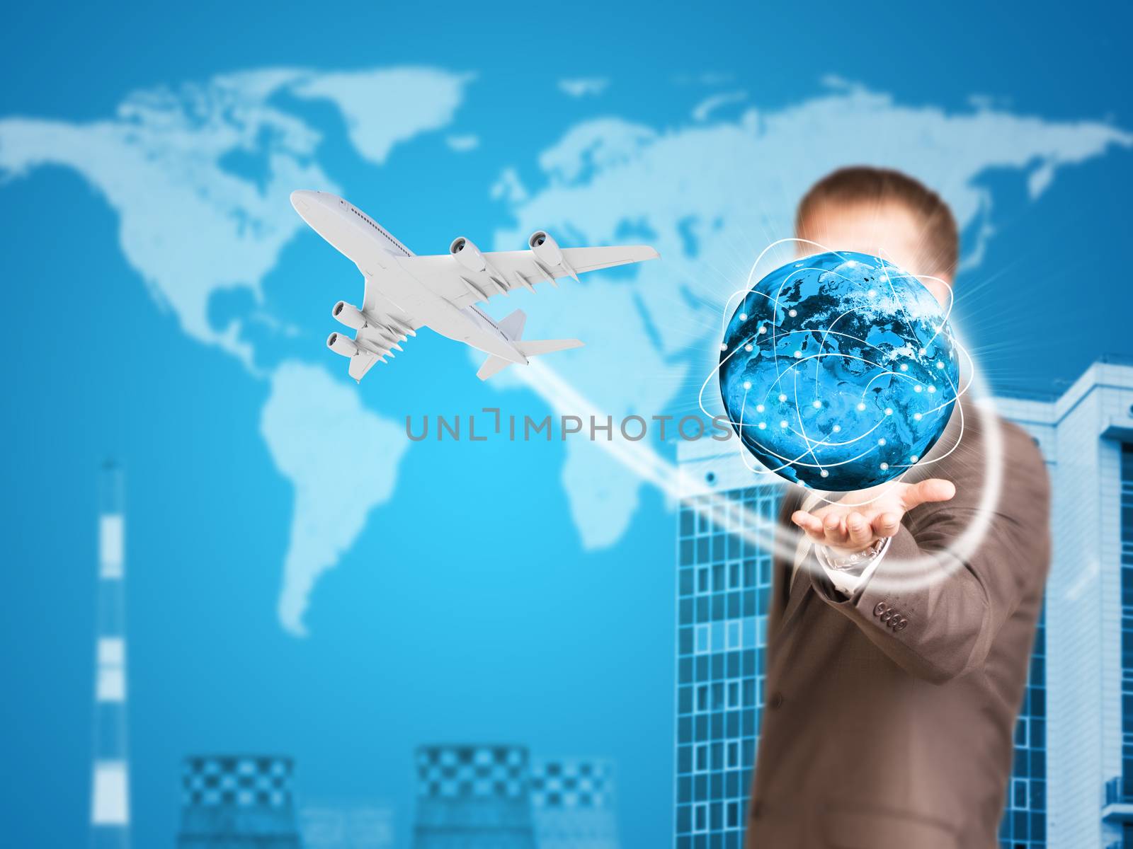 Businessman holding earth. Buildings as backdrop by cherezoff