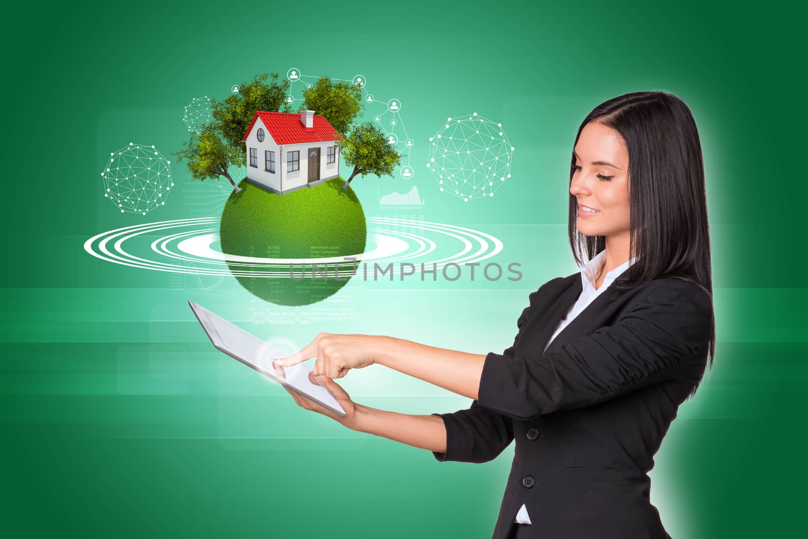 Beautiful businesswomen in suit using digital tablet. Earth with house, trees and wire-frame spheres