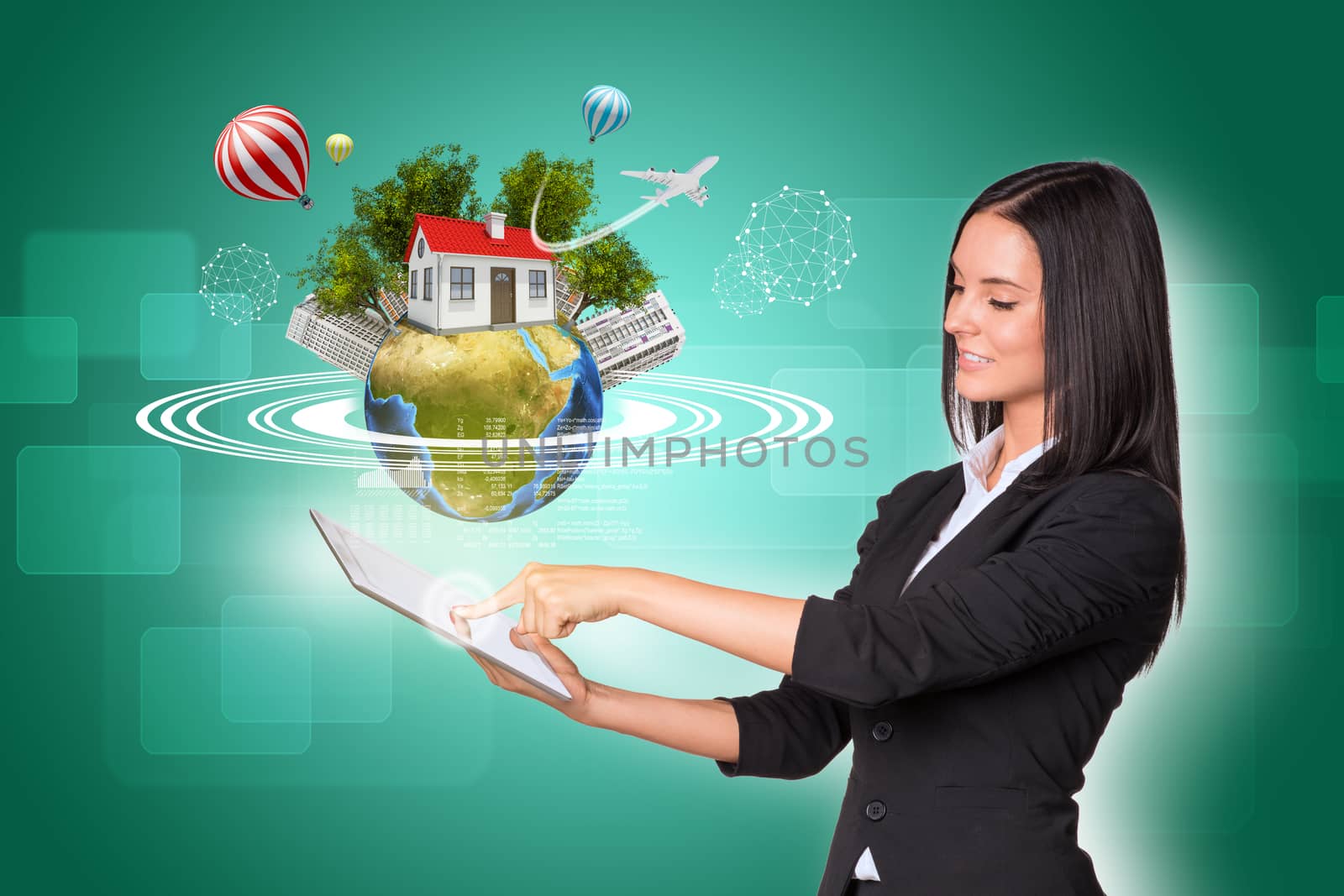 Beautiful businesswomen in suit using digital tablet. Earth with house, buildings, air balloons, trees and airplane. Element of this image furnished by NASA