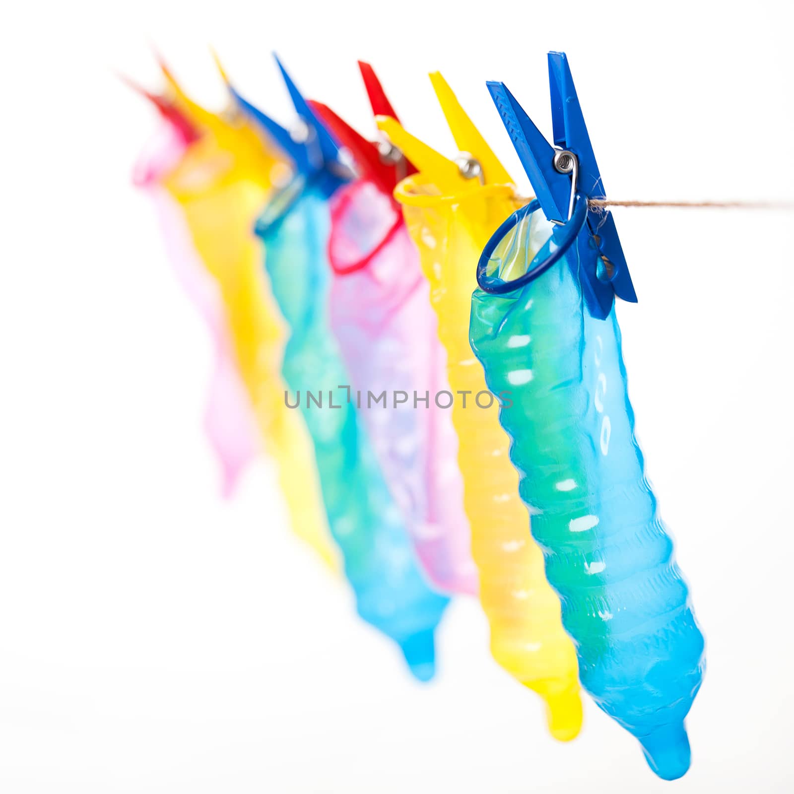 Colorful condoms on a clothespins by rufatjumali