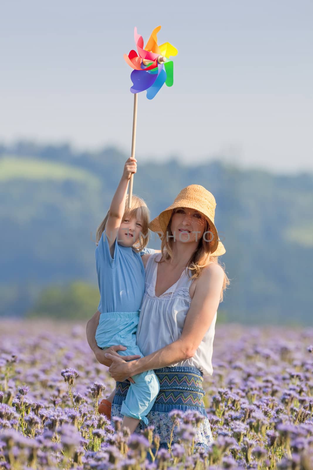 mother and son with pinwheel by courtyardpix