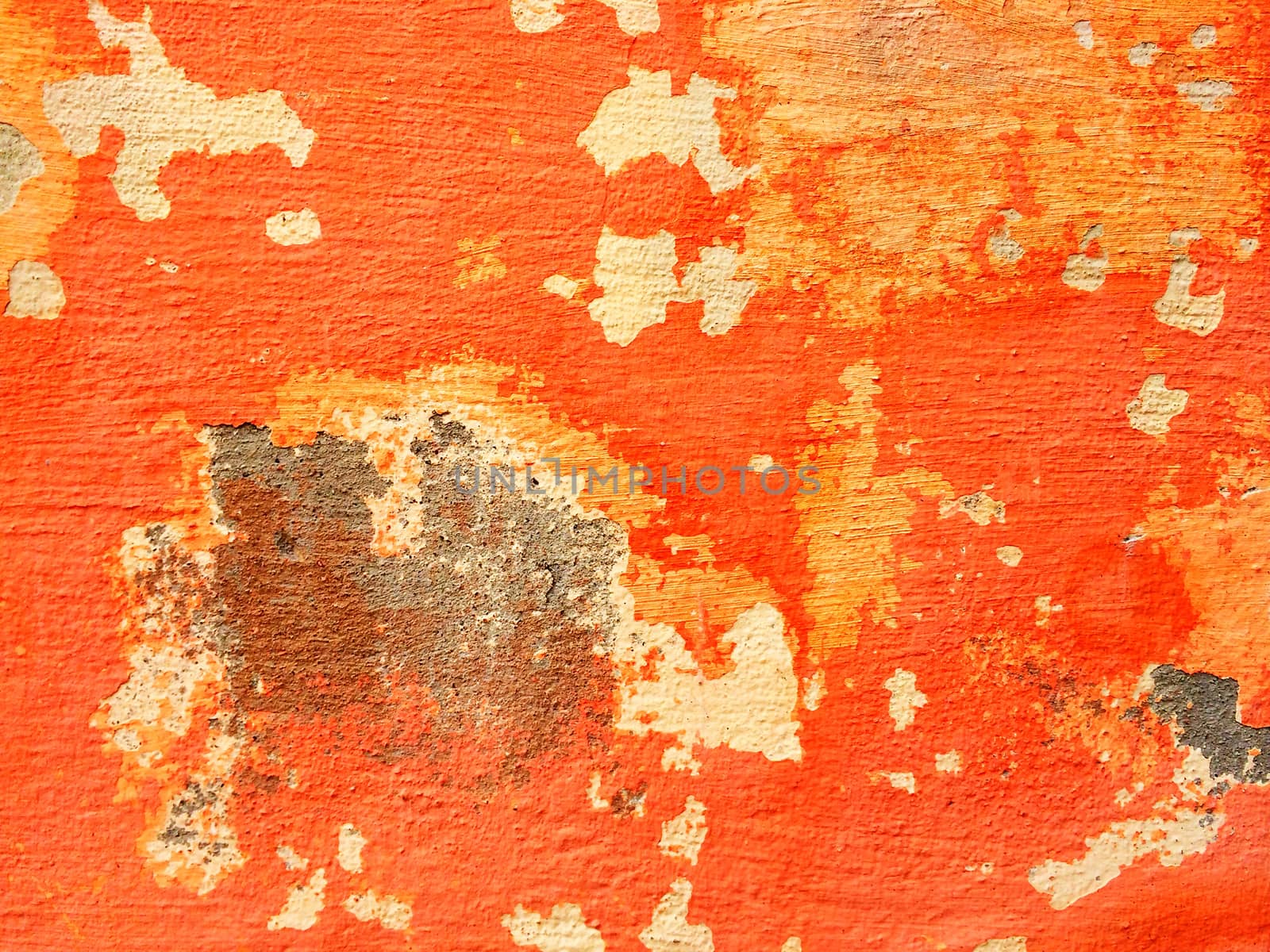 Bright orange wall with old peeling paint.